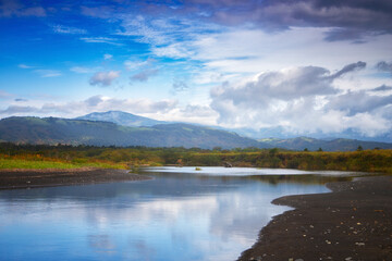 Autumn day landscape with a river. Kunashir Island, Southern Kuriles