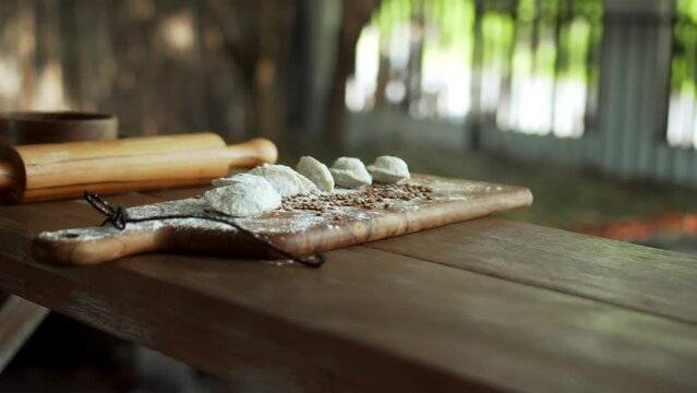 Russian fresh handmade dumplings lying on the wooden table on the cutting board