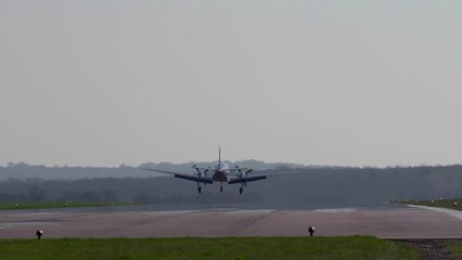 long shot of a twin engined light aircraft coming in to land.