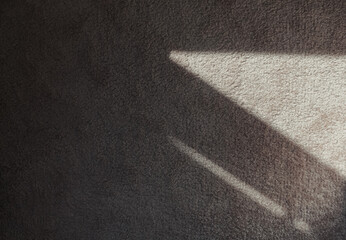 Fototapeta premium Textile carpeting. Abstract texture background. Grey soft carpet in monochromatic color with dark shadows on it.