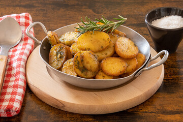 sarladaise potatoes in a dish with rosemary