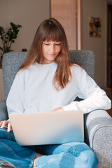 Young woman having online video chat conference from home.