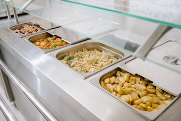 Different types of dishes in containers on the buffet table in the hotel restaurant - 498505983