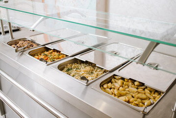 Different types of dishes in containers on the buffet table in the hotel restaurant - 498505986