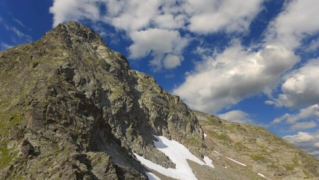 mountain backbone on blue cloudy sky background time lapse scene