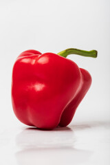 Healthy vegetables. Red pepper. Peppers are on a plate and the photo has a white background.