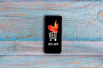 Smartphone that on its screen announces a discount of 30 percent for the hot sale.