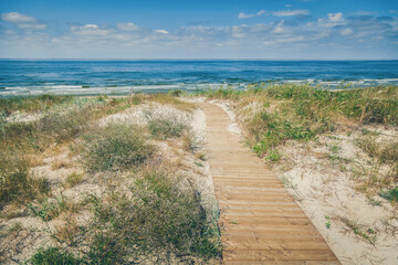 Fototapeta na wymiar Wooden walkpath to the beach