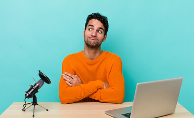 hispanic handsome man shrugging, feeling confused and uncertain. influencer concept