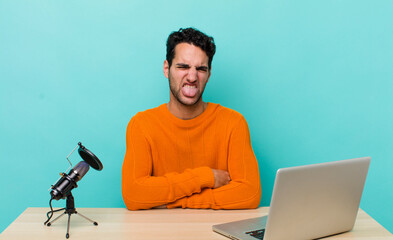 hispanic handsome man feeling disgusted and irritated and tongue out. influencer concept