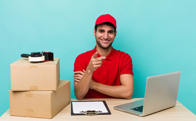 hispanic handsome man pointing at camera choosing you. packer employee concept