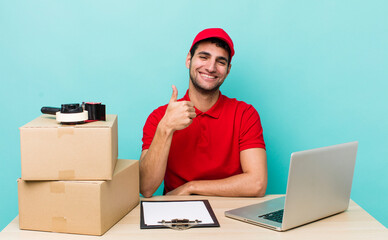 hispanic handsome man feeling proud,smiling positively with thumbs up. packer employee concept