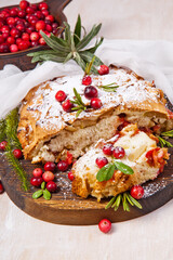 Delicious cranberry pie with fresh cranberries and herbs for Christmas on wooden plate