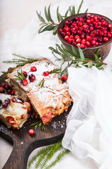 Delicious cranberry pie with fresh cranberries and herbs for Christmas on wooden plate