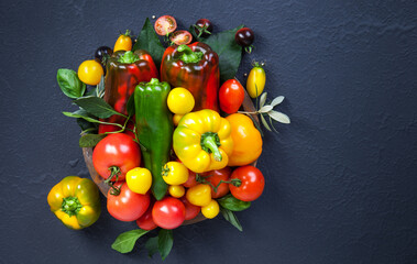Fototapeta na wymiar Assorted tomatoes and vegetables on dark background. Photo for your design.