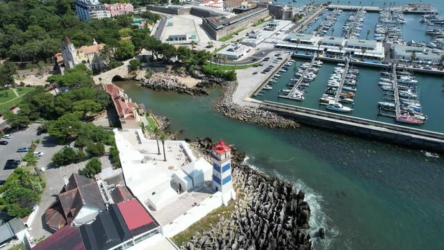 Flying from above the Santa Marta lighthouse at Cascais with view for Cascais Marina,Portugal