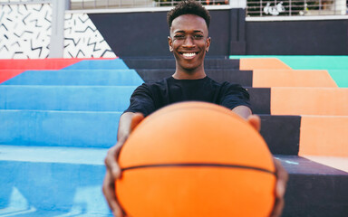Happy young african man playing basketball outdoor - College sport concept - Focus on face