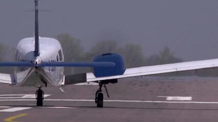 A twin engined light aircraft taking off from behind