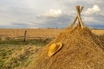 straw hat in countryside with selective focus