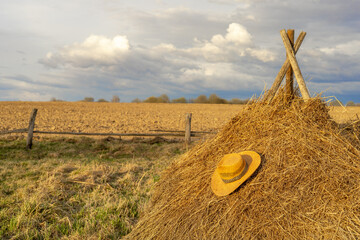 straw hat in countryside with selective focus