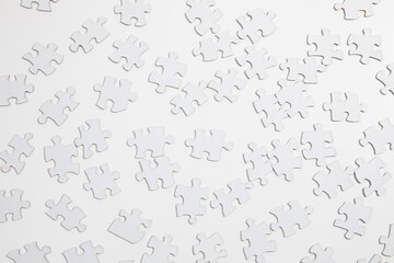 White Puzzle Pieces on White Table