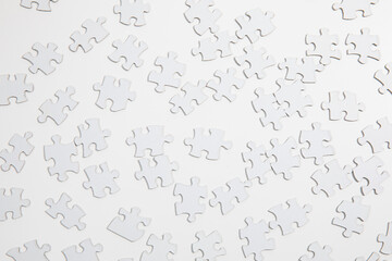 White Puzzle Pieces on White Table