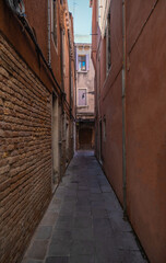 Fototapeta na wymiar View of historic houses in narrow alley in Venice, Italy
