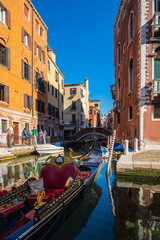 Fototapeta na wymiar VENICE, ITALY - August 27, 2021: View of empty gondola on narrow canals of Venice, Italy
