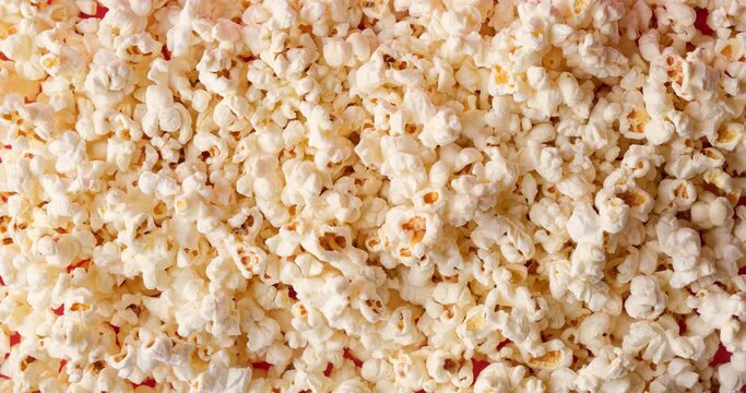 Popcorn on pink background. Looped 4K stop motion animation