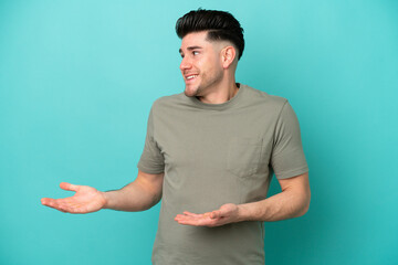 Young caucasian man isolated on blue background with surprise expression while looking side