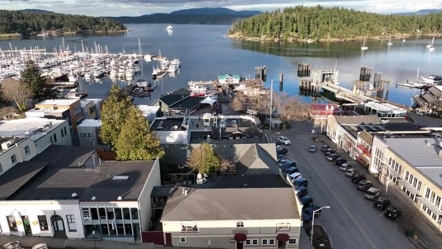Cinematic 4K aerial drone footage of Spring Street and Front Street in the Port and town of Friday Harbor with the ferry terminal, commercial zone, downriggers in the San Juan Islands