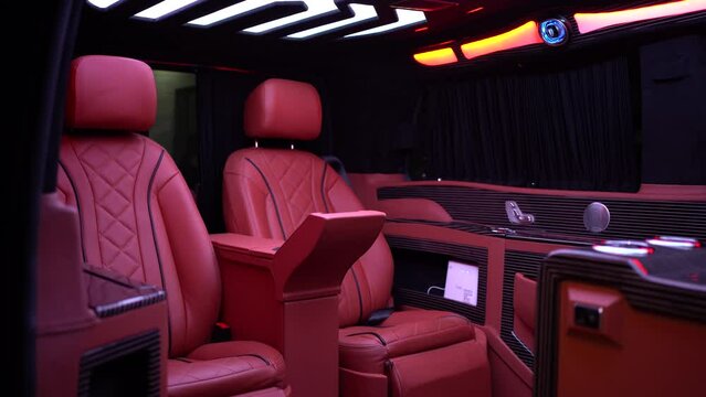 Nice interior shot of a luxurious limousine, van shuttle for business owners. Red seats with some nice LED lights on the roof. Perfect interior clip for transportation.