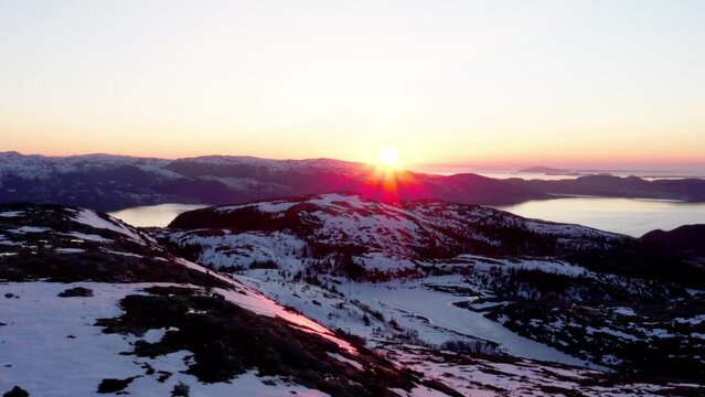 Sunset In The Snowy Mountains And Lake With Sunbeams In Blaheia, Norway. - Aerial Drone Shot