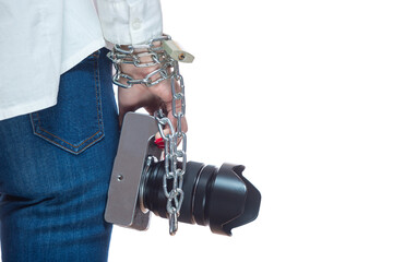Copyright. The camera is chained to the photographer's hand. The concept of protecting the photographer from theft of his photos. Isolated on white background.