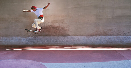 Great achievements involve great risk. Shot of a young man doing tricks on his skateboard at the skatepark. © Anne/peopleimages.com