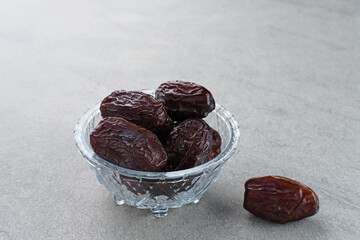 Fresh Medjool Dates Fruit served in small bowl. Space for text. Ramadan kareem. 
