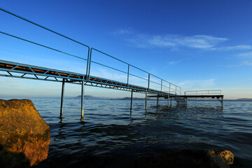 Fishing pier above Lake Balaton at blue cloudy sky