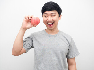 Asian man looking at red apply in hand with smiling health concept