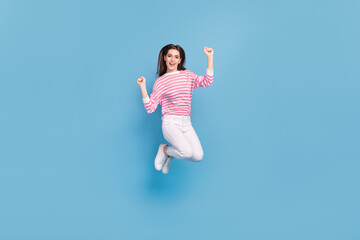 Full length photo of overjoyed cheerful lady raise fists celebrate success isolated on blue color background