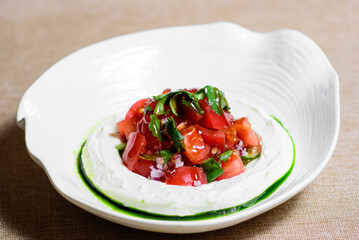 Tomato salad with cheese and mustard-garlic dressing. Tomato salad