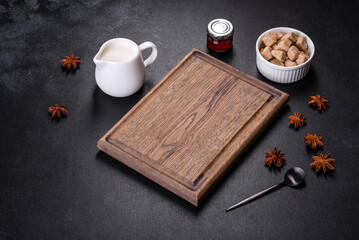 Sugar, cinnamon and other spices on a wooden cutting board