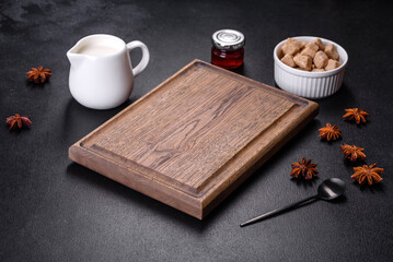 Sugar, cinnamon and other spices on a wooden cutting board