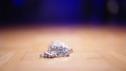 Piled up metal chain on floor under spotlight in moody light