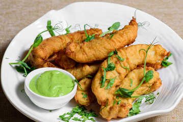 Shrimps in batter with sauce on a plate