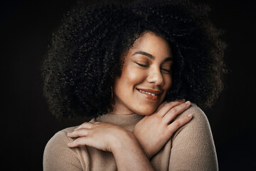 It all started with some self-love. Cropped shot of an attractive young woman posing in studio against a dark background.