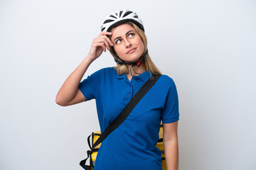 Young caucasian woman with thermal backpack isolated on white background having doubts and with confuse face expression