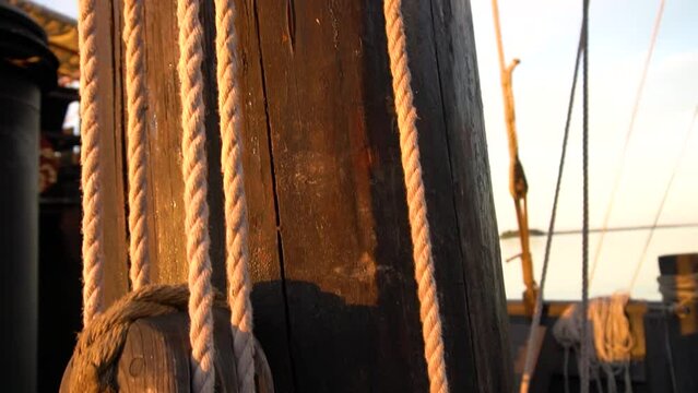 Old Cog Ship Ropes and Wooden Hoist lit by an Evening Sun