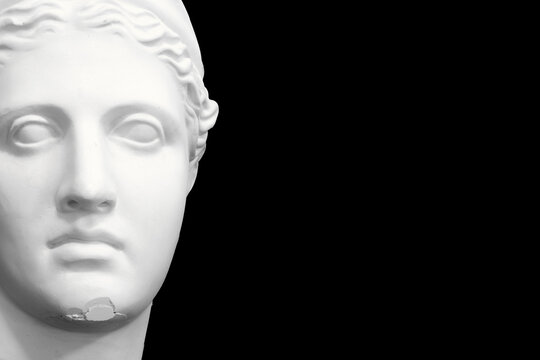 white plaster female statue isolated on black background