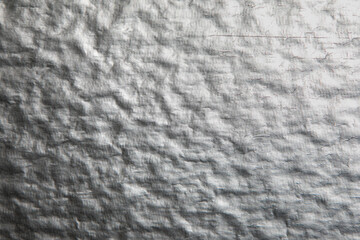 Texture of the wall covered with silver paint