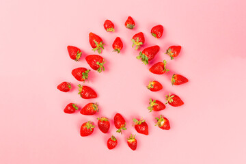 strawberries lined up on pink background